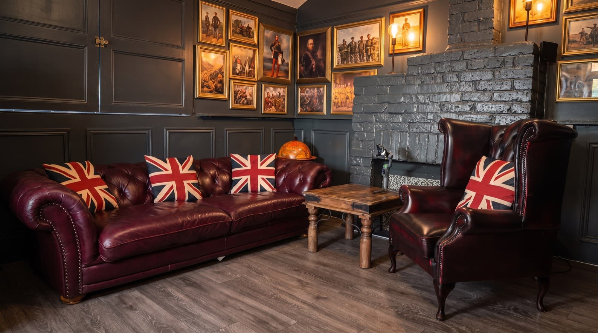 The Anteroom, with Chesterfield seating, the fireplace, and warm lamps